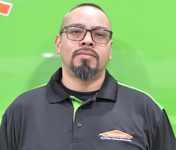 SERVPRO employee in front of green background