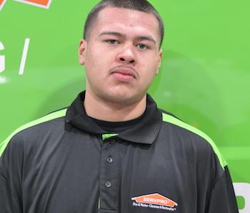 SERVPRO employee in front of green background